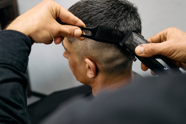 Barber giving a precise fade haircut