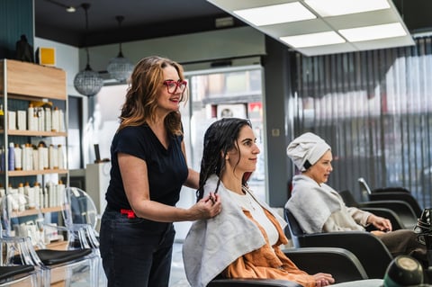 Hairstylist working with client at Luxe Lounge salon